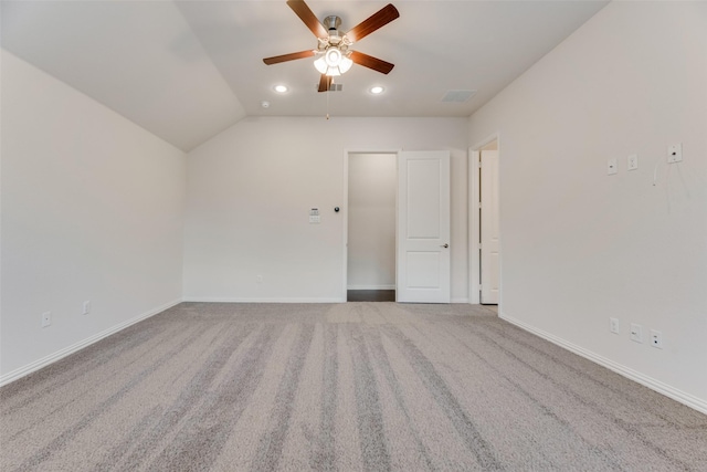 unfurnished room featuring carpet, ceiling fan, and vaulted ceiling