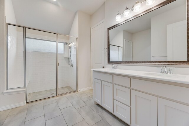 bathroom featuring tile patterned flooring, vanity, and walk in shower