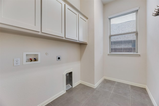 clothes washing area with gas dryer hookup, cabinets, hookup for a washing machine, light tile patterned floors, and hookup for an electric dryer