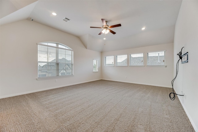 unfurnished room featuring ceiling fan, carpet, and vaulted ceiling