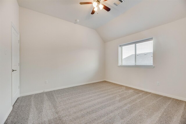 empty room with carpet, ceiling fan, and vaulted ceiling