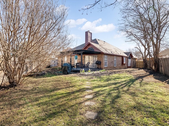 back of property featuring a lawn and a patio