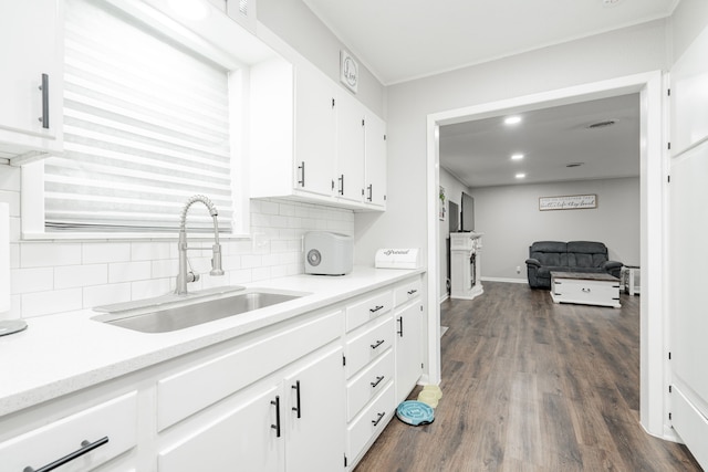 kitchen with white cabinets, tasteful backsplash, dark wood-type flooring, and sink