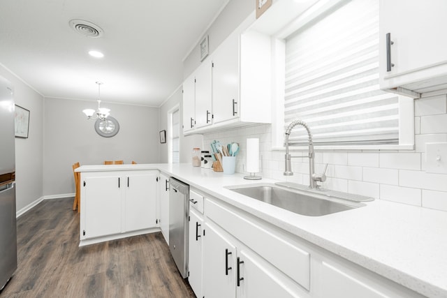 kitchen with white cabinets, sink, hanging light fixtures, stainless steel dishwasher, and dark hardwood / wood-style floors