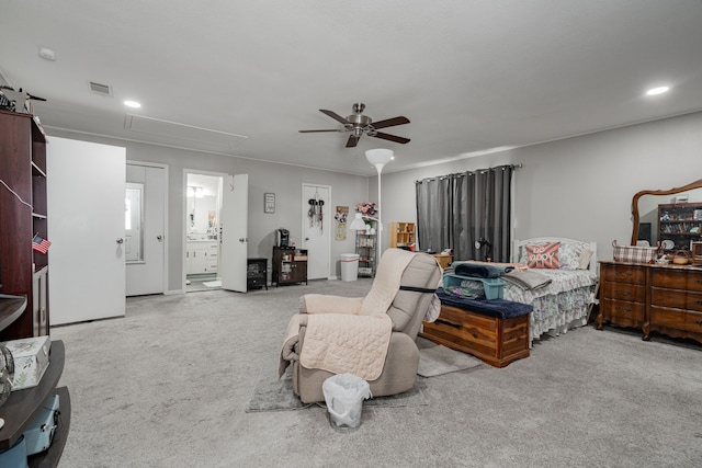 carpeted bedroom featuring ensuite bath and ceiling fan