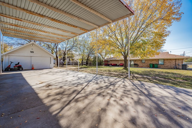 view of patio / terrace with central AC, a garage, a carport, and an outdoor structure