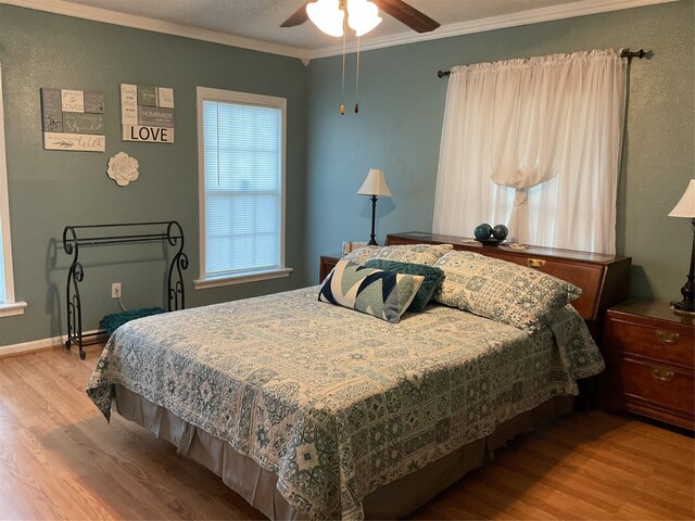 bedroom featuring wood-type flooring, ceiling fan, and crown molding