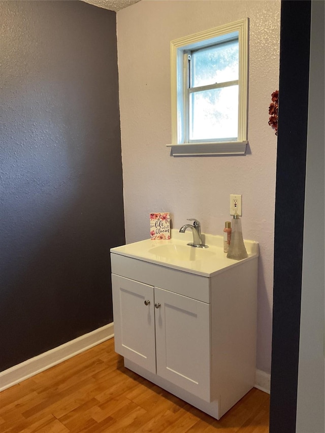 bathroom featuring vanity and wood-type flooring