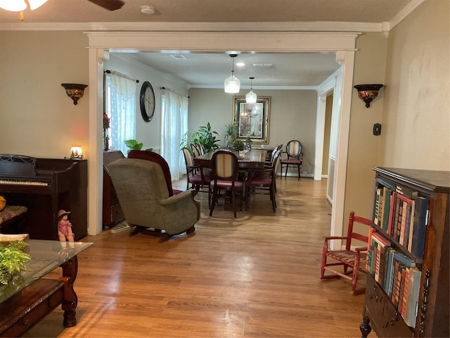 dining room featuring wood-type flooring and crown molding