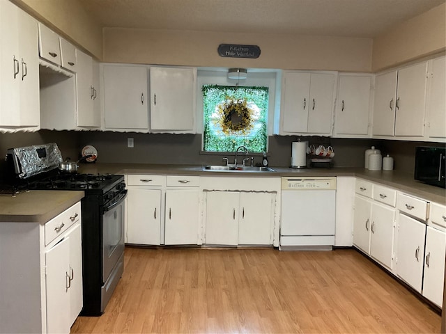 kitchen with dishwasher, white cabinetry, sink, and stainless steel range with gas stovetop