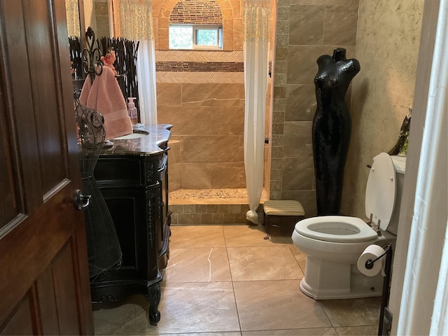 bathroom with curtained shower, tile patterned flooring, vanity, and toilet