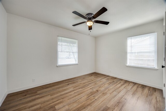 unfurnished room with ceiling fan and light wood-type flooring