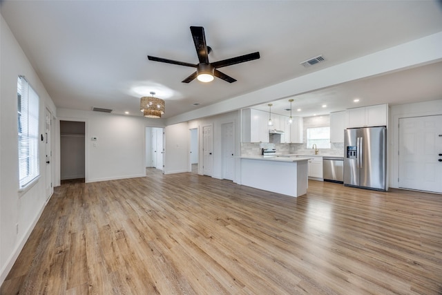 unfurnished living room featuring light hardwood / wood-style floors and ceiling fan