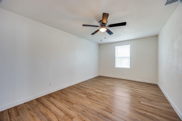 spare room featuring light hardwood / wood-style flooring and ceiling fan