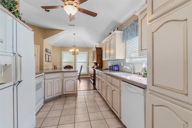 kitchen featuring white appliances, backsplash, sink, hanging light fixtures, and a textured ceiling