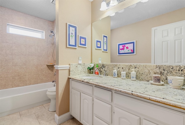 full bathroom with vanity, a textured ceiling, tiled shower / bath combo, tile patterned flooring, and toilet