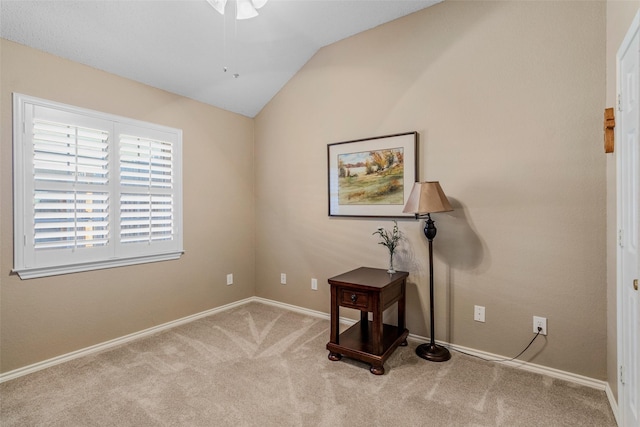 interior space featuring light colored carpet and lofted ceiling