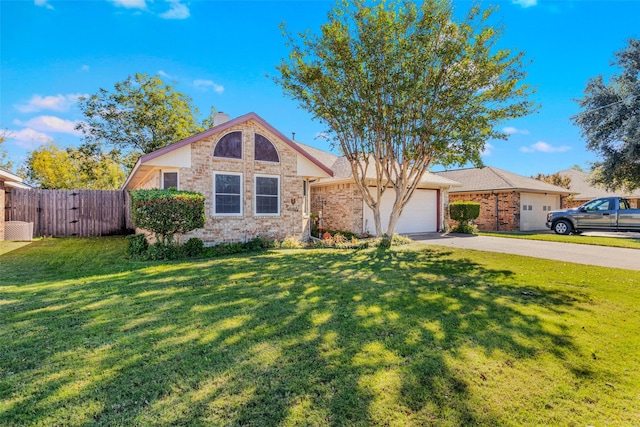 view of front of home featuring a garage and a front lawn