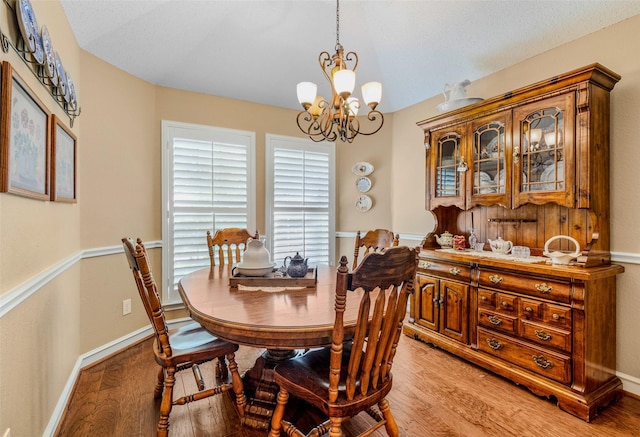 dining room featuring light hardwood / wood-style floors and an inviting chandelier