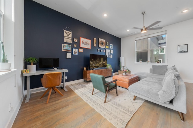 living room with ceiling fan and hardwood / wood-style flooring