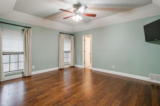 unfurnished room featuring ceiling fan and dark wood-type flooring