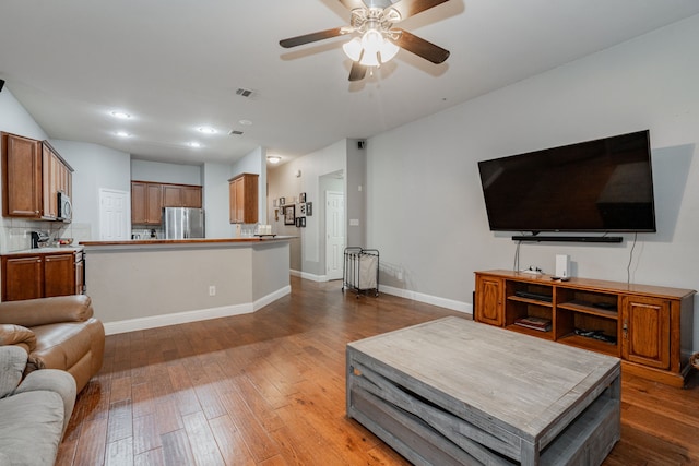 living room with hardwood / wood-style floors and ceiling fan