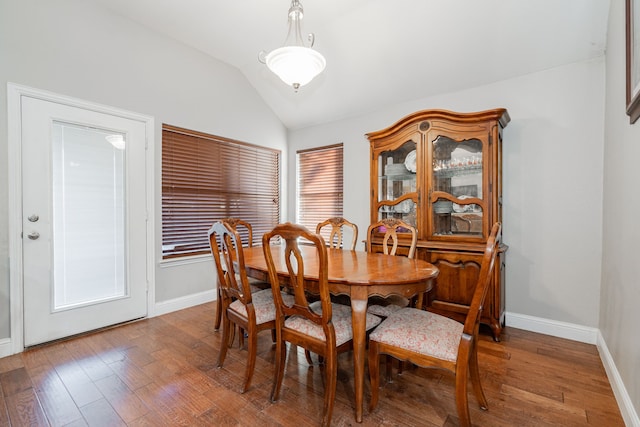 dining room featuring hardwood / wood-style floors and lofted ceiling