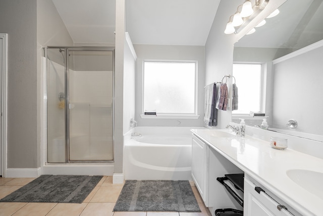 bathroom with tile patterned floors, vanity, plus walk in shower, and vaulted ceiling