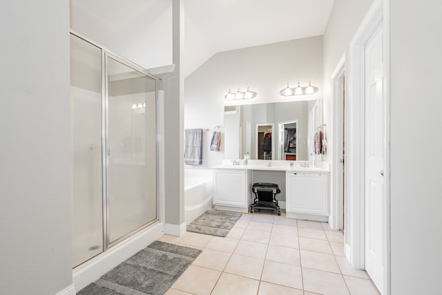 bathroom featuring tile patterned flooring, shower with separate bathtub, vanity, and lofted ceiling