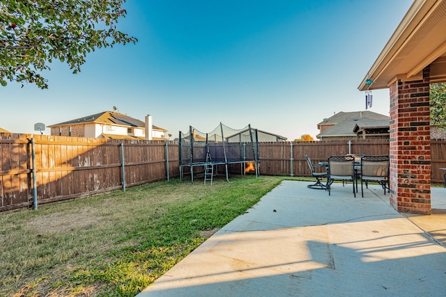 view of yard featuring a patio and a trampoline