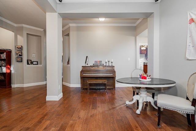 dining space with crown molding and dark wood-type flooring