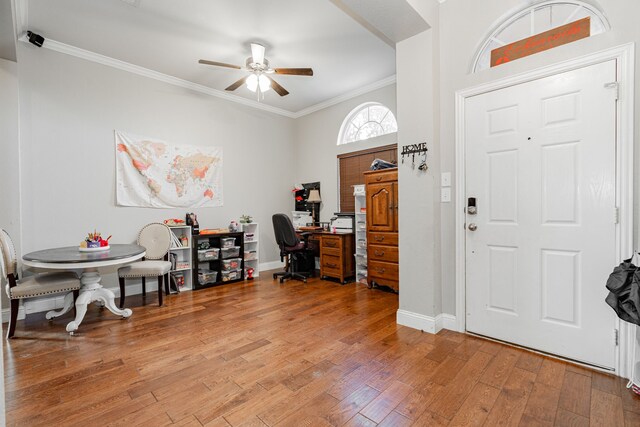 entrance foyer featuring ceiling fan, crown molding, and wood-type flooring