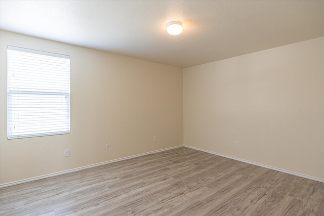 unfurnished room with light hardwood / wood-style flooring