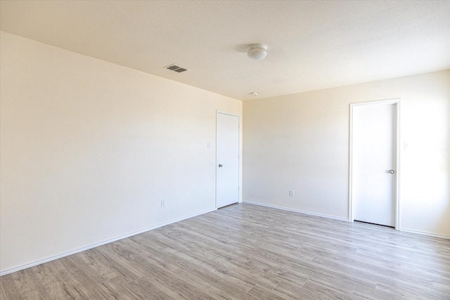 spare room featuring light hardwood / wood-style floors