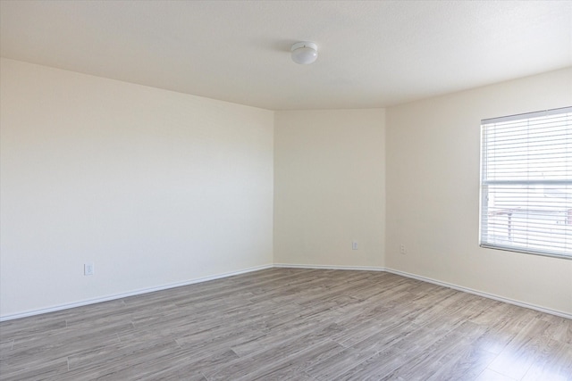 unfurnished room with light hardwood / wood-style flooring