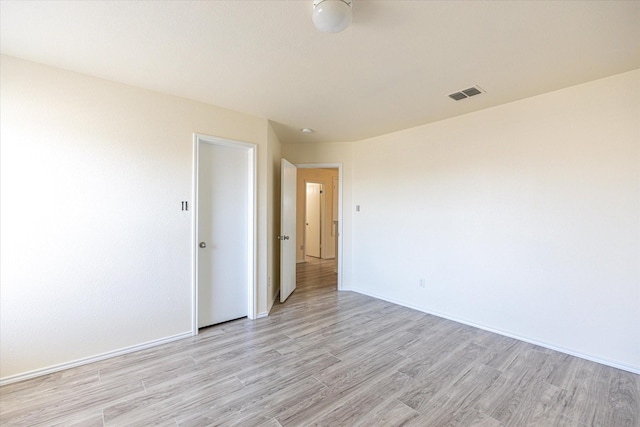 unfurnished room with light wood-type flooring