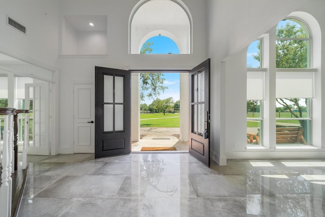 foyer entrance with french doors and a high ceiling