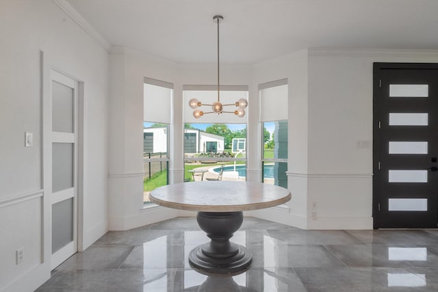 entryway with a notable chandelier and ornamental molding