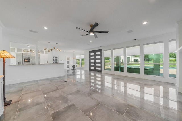 unfurnished living room with ceiling fan