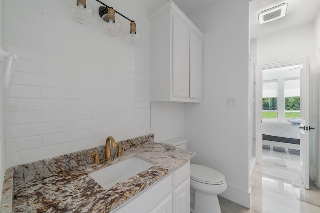 bathroom featuring vanity and toilet