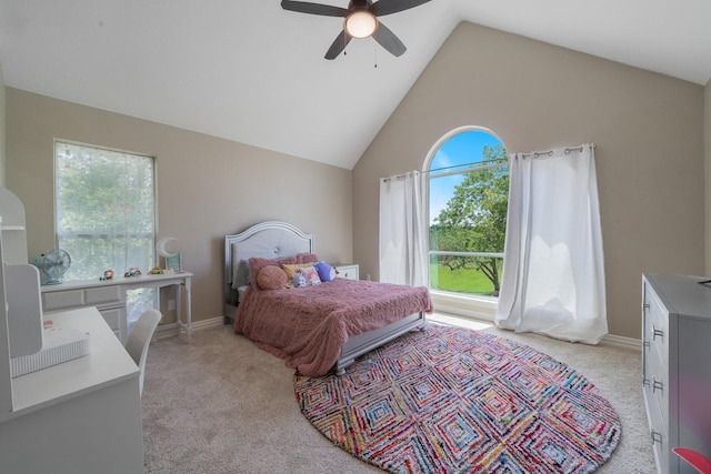 carpeted bedroom with multiple windows, ceiling fan, and vaulted ceiling