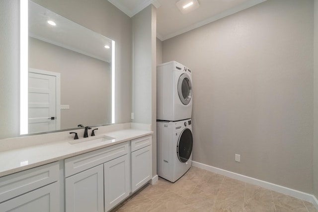 laundry room with crown molding, stacked washer and clothes dryer, and sink