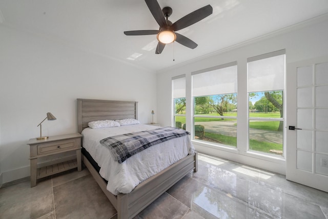 bedroom with ceiling fan and crown molding