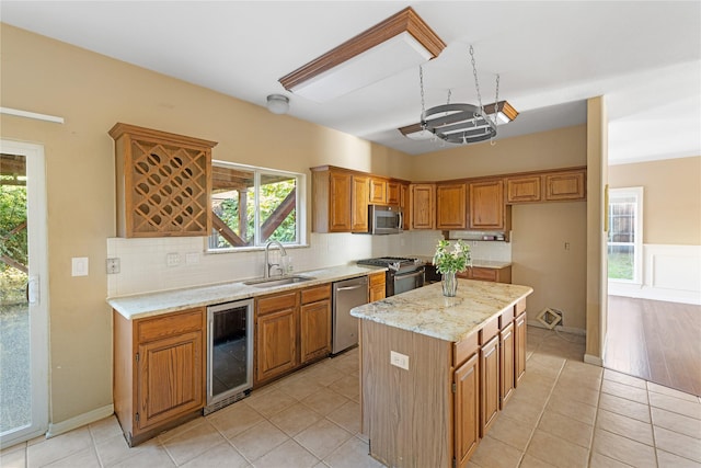 4307 Sausalito Dr, Dallas, TX 75287 - kitchen featuring wine cooler, sink, appliances with stainless steel finishes, a kitchen island, and backsplash