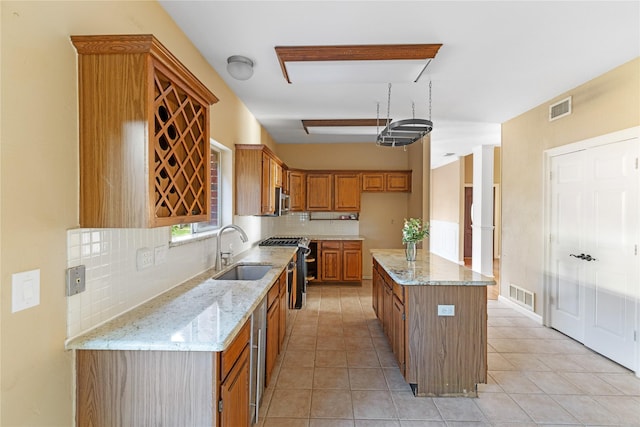 4307 Sausalito Dr, Dallas, TX 75287 - kitchen featuring light tile patterned flooring, a kitchen island, sink, backsplash, and light stone countertops