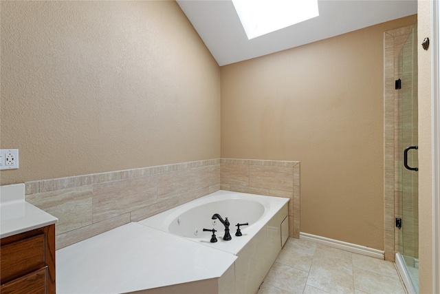 4307 Sausalito Dr, Dallas, TX 75287 - bathroom with vanity, vaulted ceiling with skylight, tile patterned flooring, and shower with separate bathtub