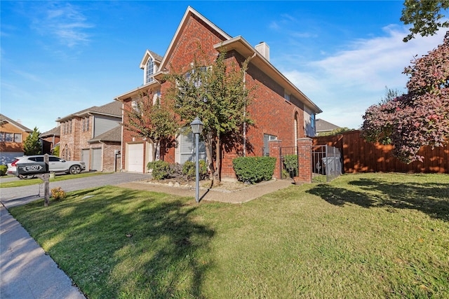 view of front of property with a garage and a front lawn