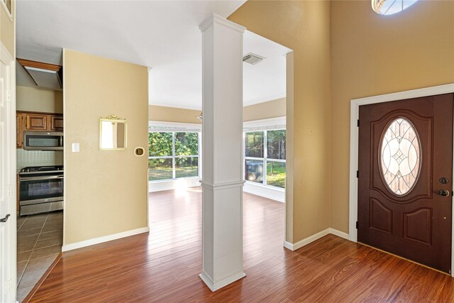 4307 Sausalito Dr, Dallas, TX 75287 - foyer with ornate columns and hardwood / wood-style flooring
