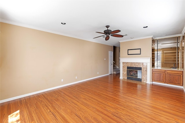 4307 Sausalito Dr, Dallas, TX 75287 - unfurnished living room featuring sink, ornamental molding, hardwood / wood-style flooring, ceiling fan, and a high end fireplace
