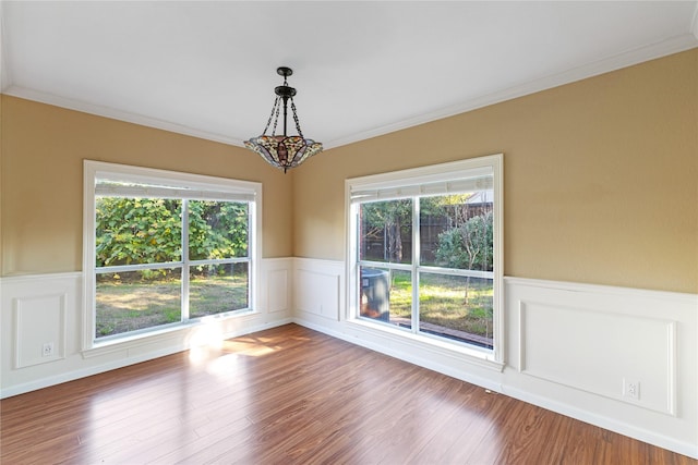 4307 Sausalito Dr, Dallas, TX 75287 - unfurnished dining area with wood-type flooring, ornamental molding, and a healthy amount of sunlight